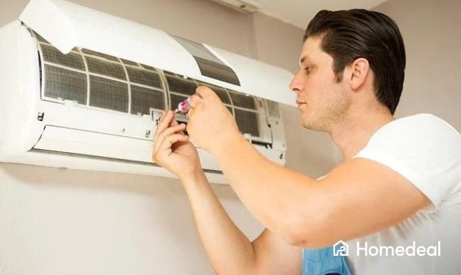 Airco vakspecialist bezig met onderhoud van een airco